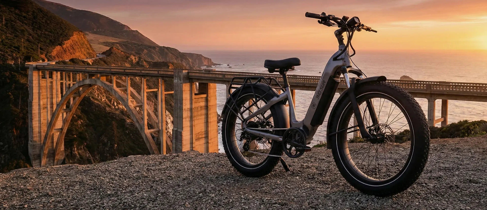 Electric bike parked on a scenic coastal road with a sunset in the background